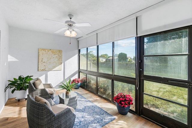 sunroom featuring ceiling fan