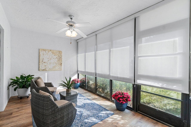 sunroom featuring ceiling fan