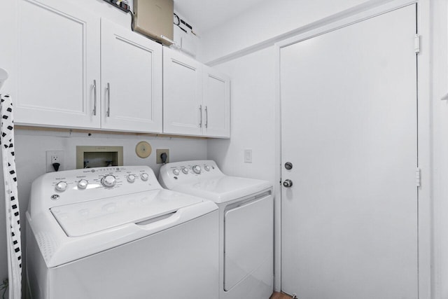 laundry area with cabinets and washing machine and dryer