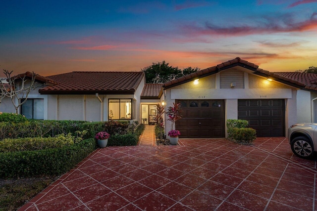 mediterranean / spanish-style home with a garage