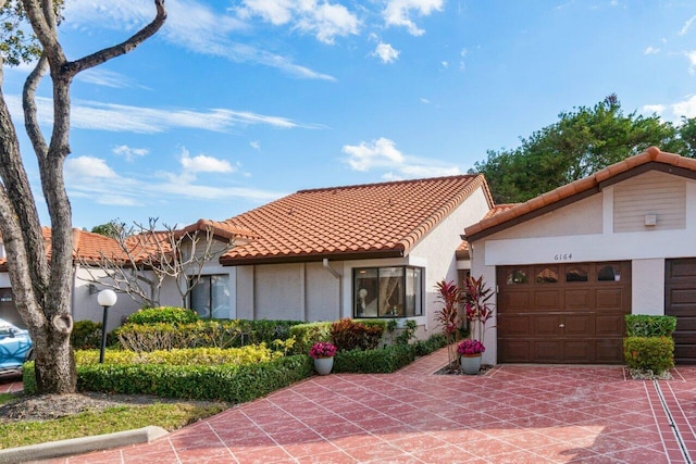 mediterranean / spanish house with a garage