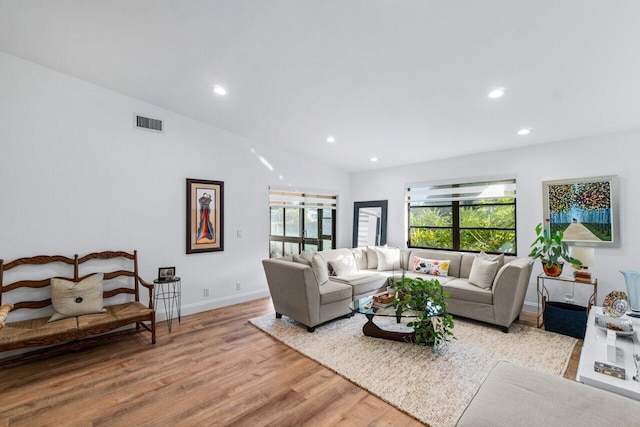 living room featuring light wood-type flooring and lofted ceiling