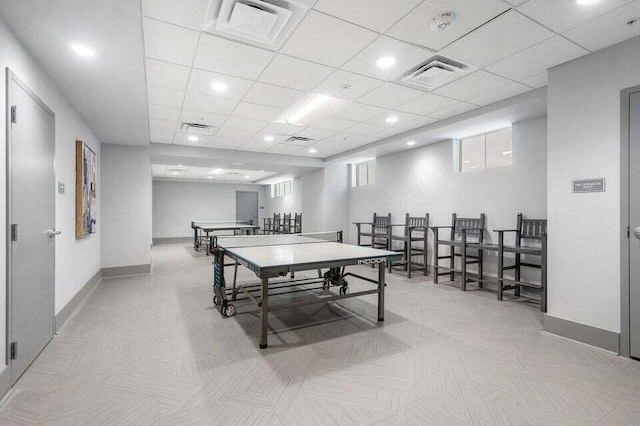 recreation room featuring a paneled ceiling