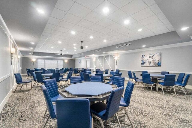 dining space featuring carpet and a tray ceiling