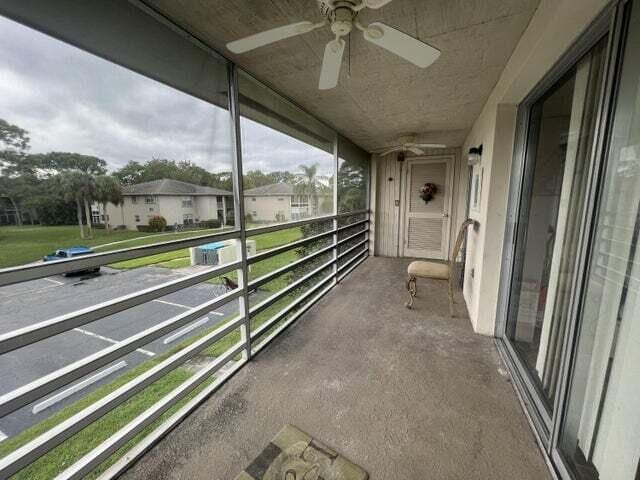 unfurnished sunroom featuring ceiling fan