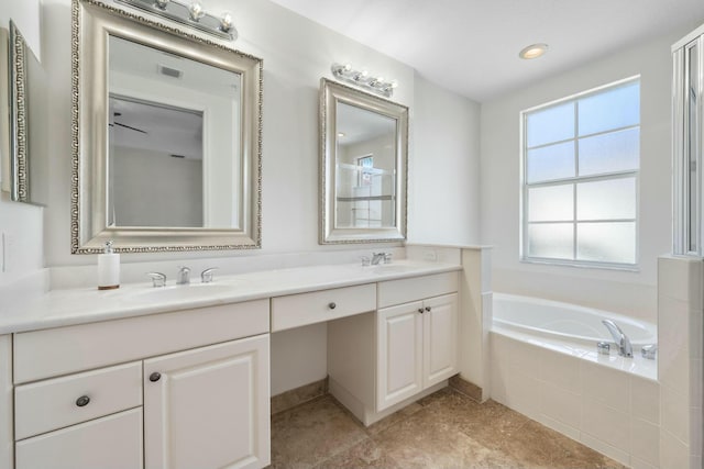 bathroom featuring vanity and tiled bath