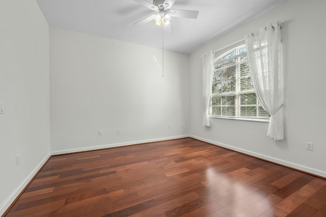 spare room with ceiling fan and dark wood-type flooring