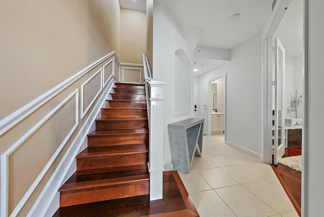 staircase featuring tile patterned floors