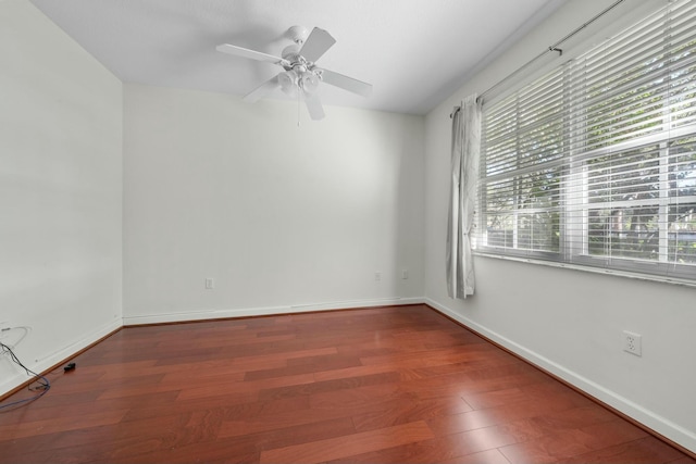 spare room with hardwood / wood-style flooring, a wealth of natural light, and ceiling fan