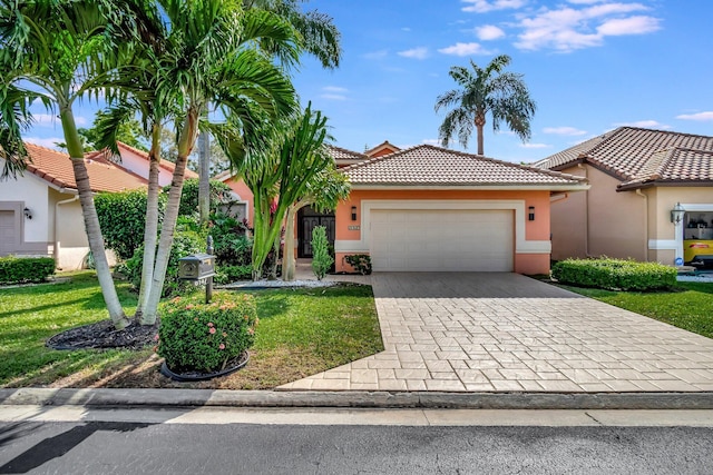 mediterranean / spanish home featuring a garage and a front lawn