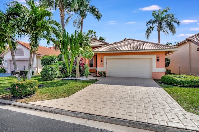 mediterranean / spanish-style house featuring a garage and a front lawn