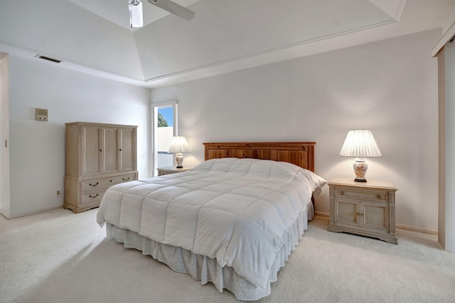 bedroom with ceiling fan, light carpet, and a raised ceiling