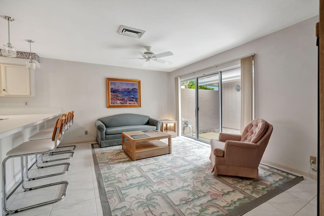 tiled living room with ceiling fan