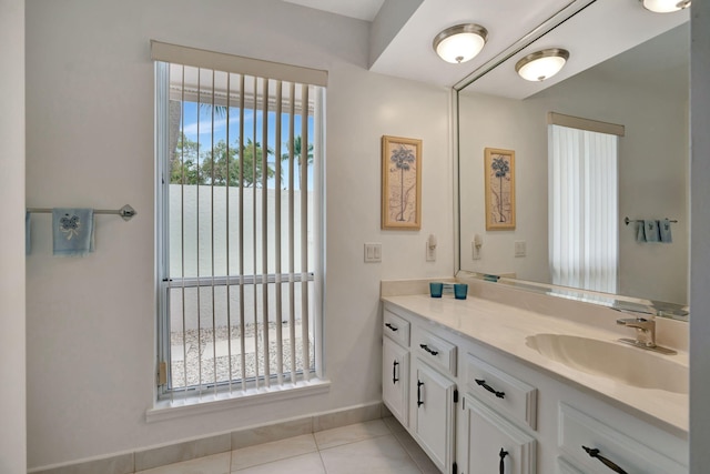 bathroom featuring vanity, a healthy amount of sunlight, and tile patterned flooring