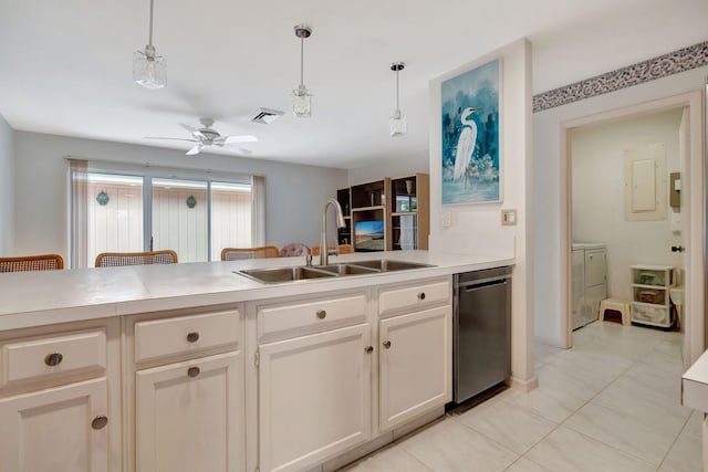 kitchen featuring stainless steel dishwasher, pendant lighting, ceiling fan, sink, and independent washer and dryer