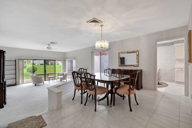 dining room featuring ceiling fan with notable chandelier, light colored carpet, and a healthy amount of sunlight