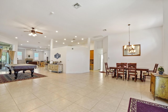 interior space featuring light tile patterned floors, ceiling fan with notable chandelier, and pool table