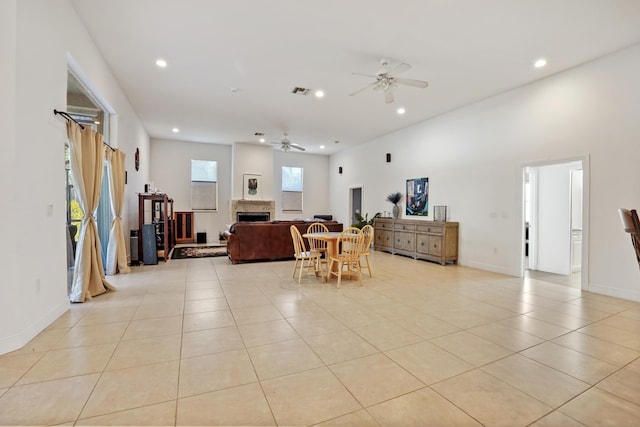 living room featuring ceiling fan and light tile patterned flooring