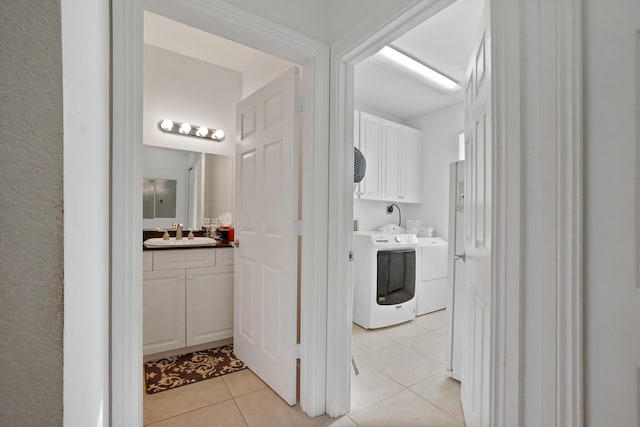 bathroom with tile patterned flooring, vanity, and washer and dryer