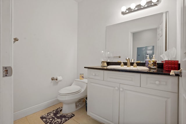 bathroom featuring tile patterned floors, vanity, and toilet