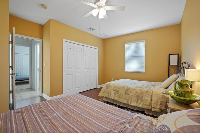 bedroom with ceiling fan and a closet