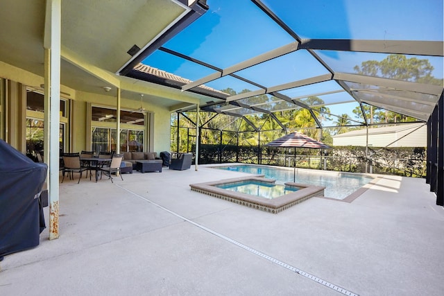 view of pool with a lanai, an in ground hot tub, ceiling fan, and a patio