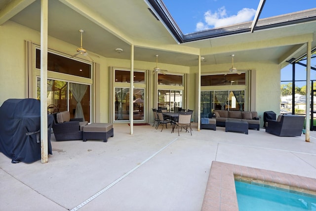 view of patio / terrace featuring an outdoor living space, glass enclosure, and ceiling fan