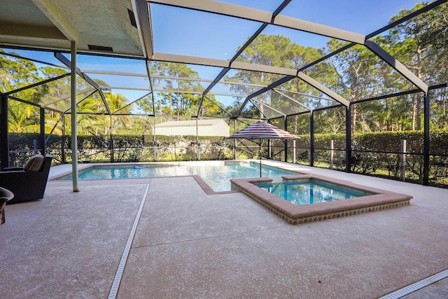 view of pool featuring an in ground hot tub, a patio, and glass enclosure