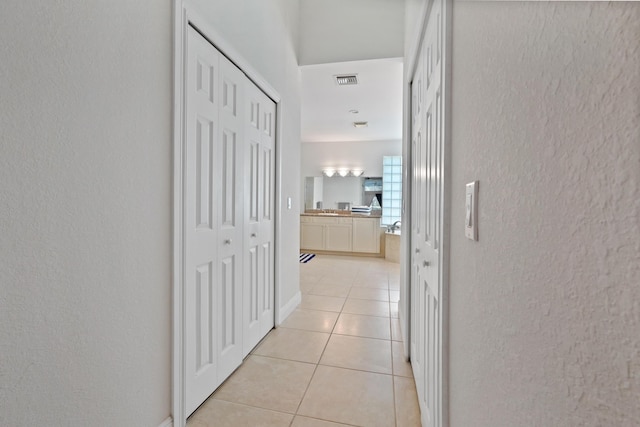 hallway with light tile patterned floors