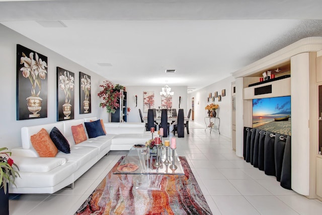 tiled living room with an inviting chandelier