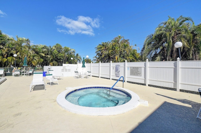 view of swimming pool featuring a community hot tub and a patio area