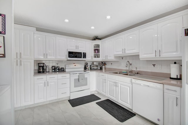 kitchen featuring white cabinets, white appliances, and sink