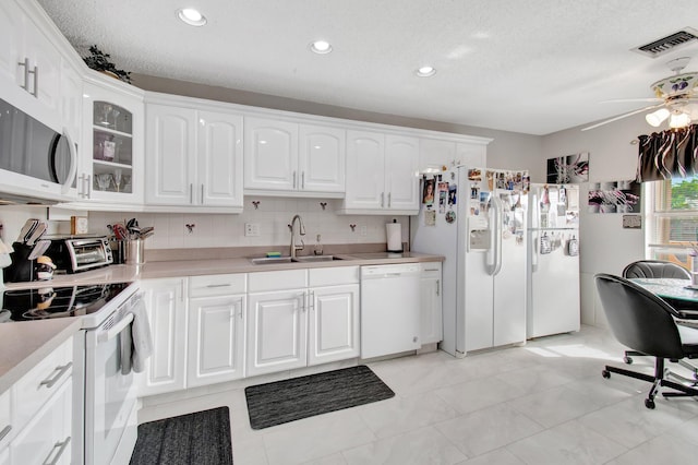 kitchen featuring white cabinetry, sink, ceiling fan, and white appliances