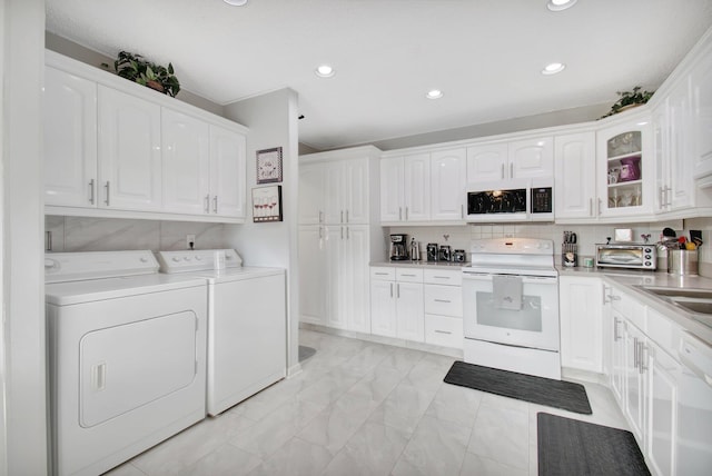 washroom featuring washer and clothes dryer and sink