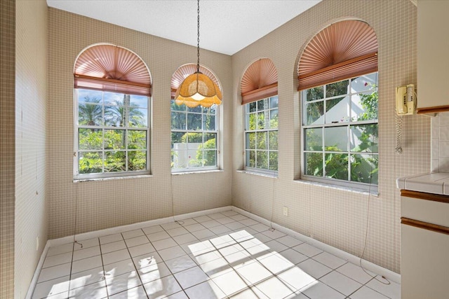 unfurnished dining area featuring light tile patterned floors