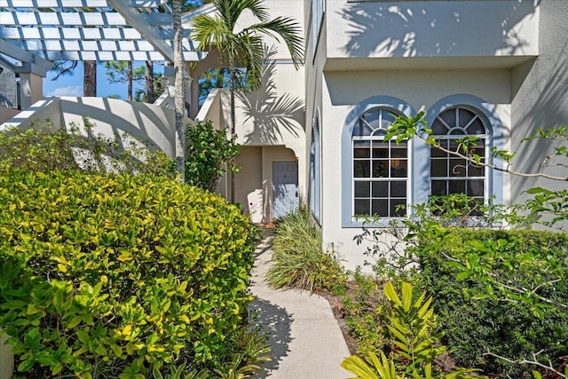 view of side of property with a pergola