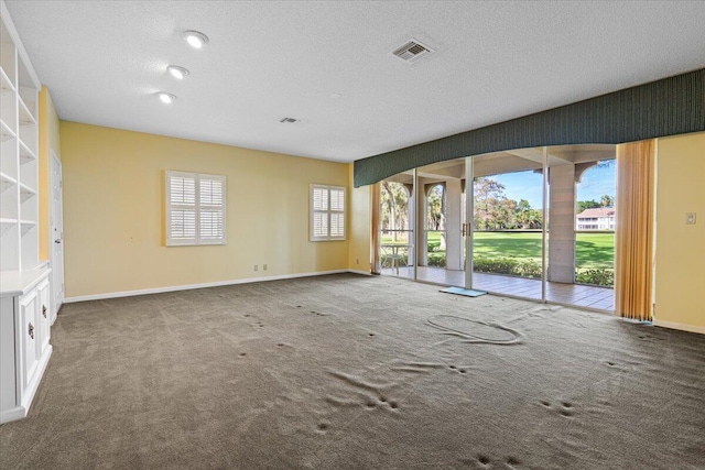 empty room featuring carpet and a textured ceiling