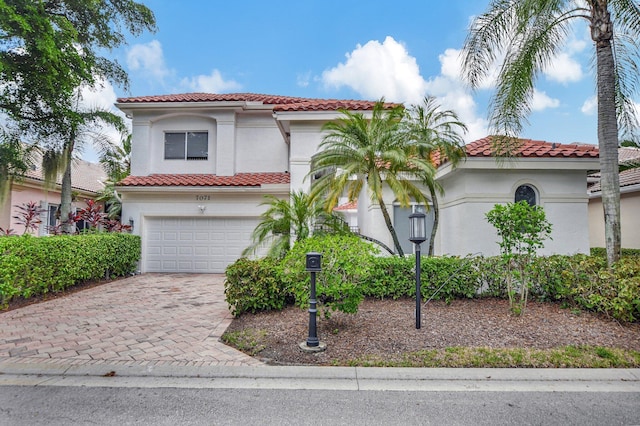 mediterranean / spanish-style home featuring a garage