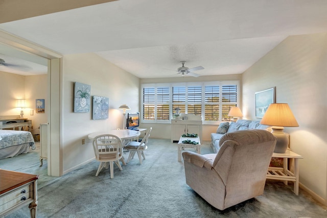 carpeted living room with ceiling fan