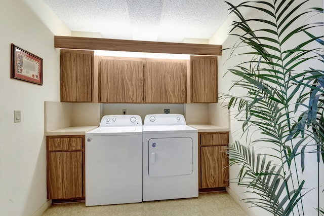 laundry room with cabinets and separate washer and dryer