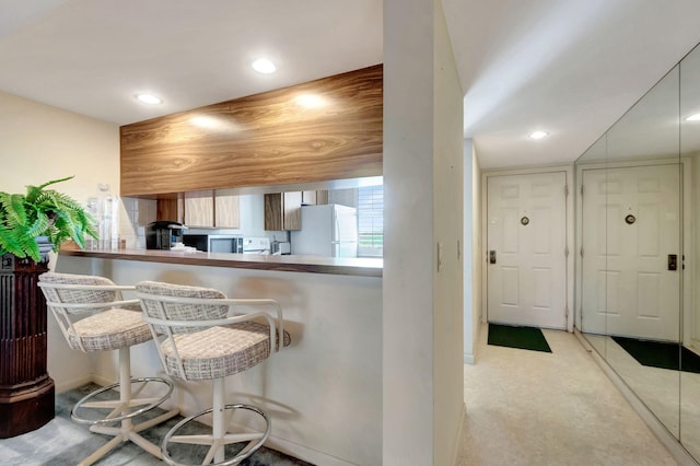 kitchen featuring white refrigerator and kitchen peninsula