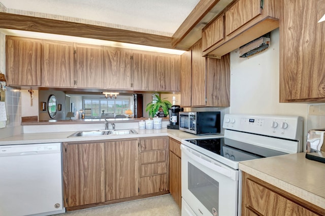 kitchen featuring white appliances and sink