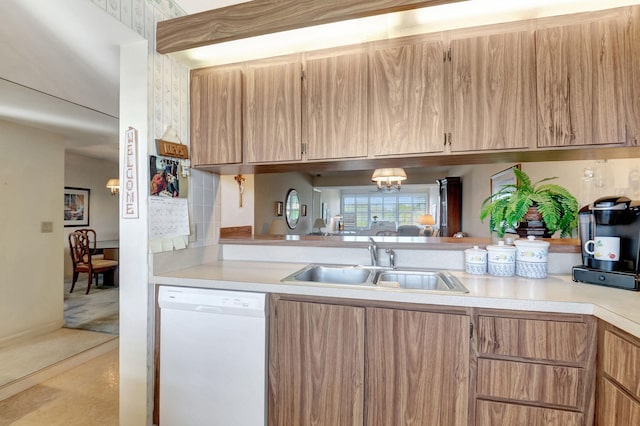 kitchen with dishwasher, a notable chandelier, and sink