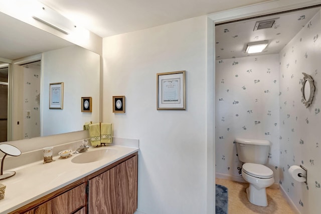 bathroom featuring vanity and toilet