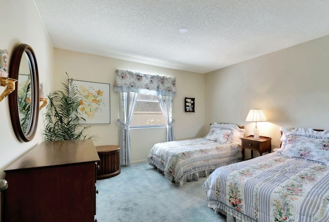 bedroom with light carpet and a textured ceiling