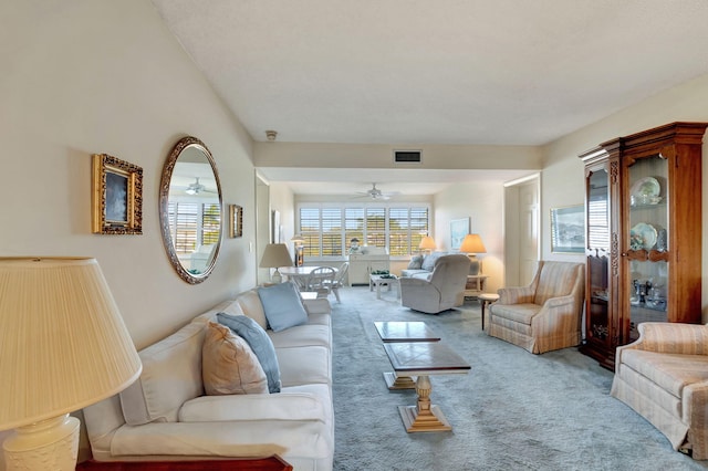 carpeted living room featuring ceiling fan