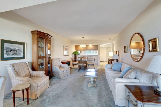 living room with light carpet and a chandelier