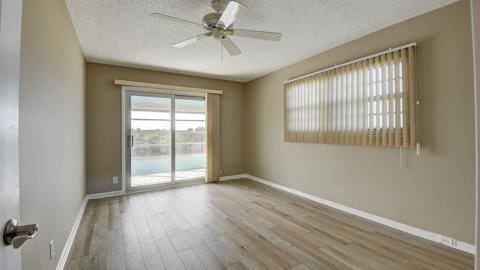 unfurnished room featuring a textured ceiling, ceiling fan, and light hardwood / wood-style flooring