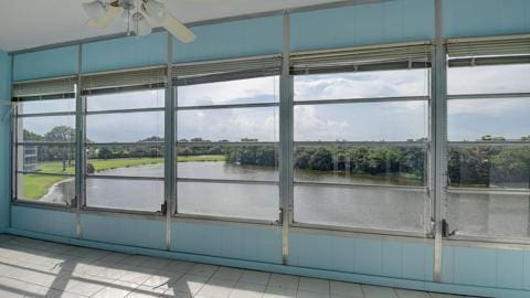 exterior space featuring a water view and ceiling fan