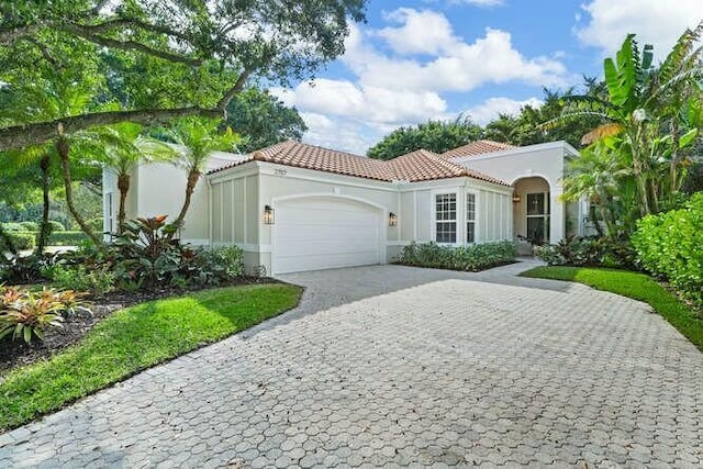 mediterranean / spanish-style house featuring a garage